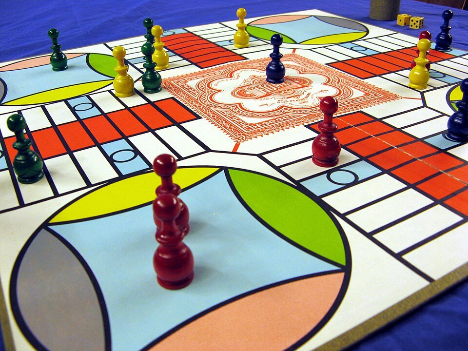 Parcheesi board and game men pieces
