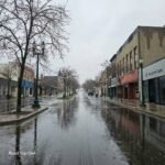 Rainy day on a downtown street in Petoskey, Michigan with wet pavement and reflections
