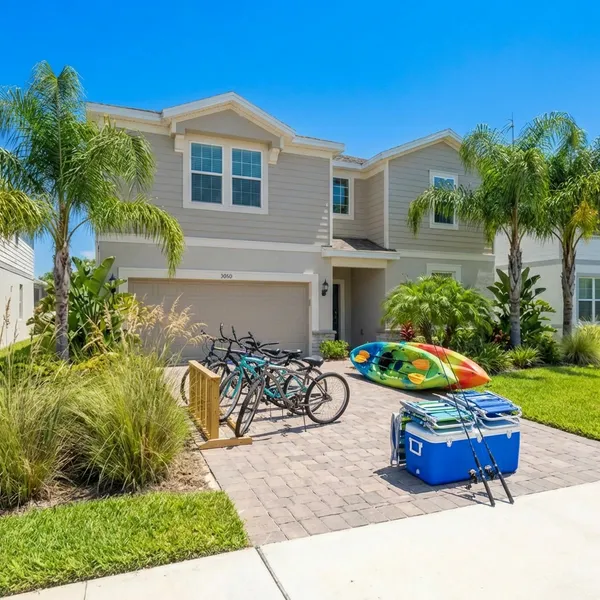 Same vacation rental home with bikes, kayaks, and beach gear visible - shows property is fully equipped for activities
