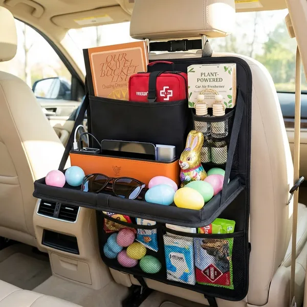 Adult road trip Easter basket made from a backseat car organizer filled with a travel bucket list planner, first aid kit, car air freshener, car seat gap filler, sunglasses, portable charger, chocolate Easter bunny, and pastel Easter eggs