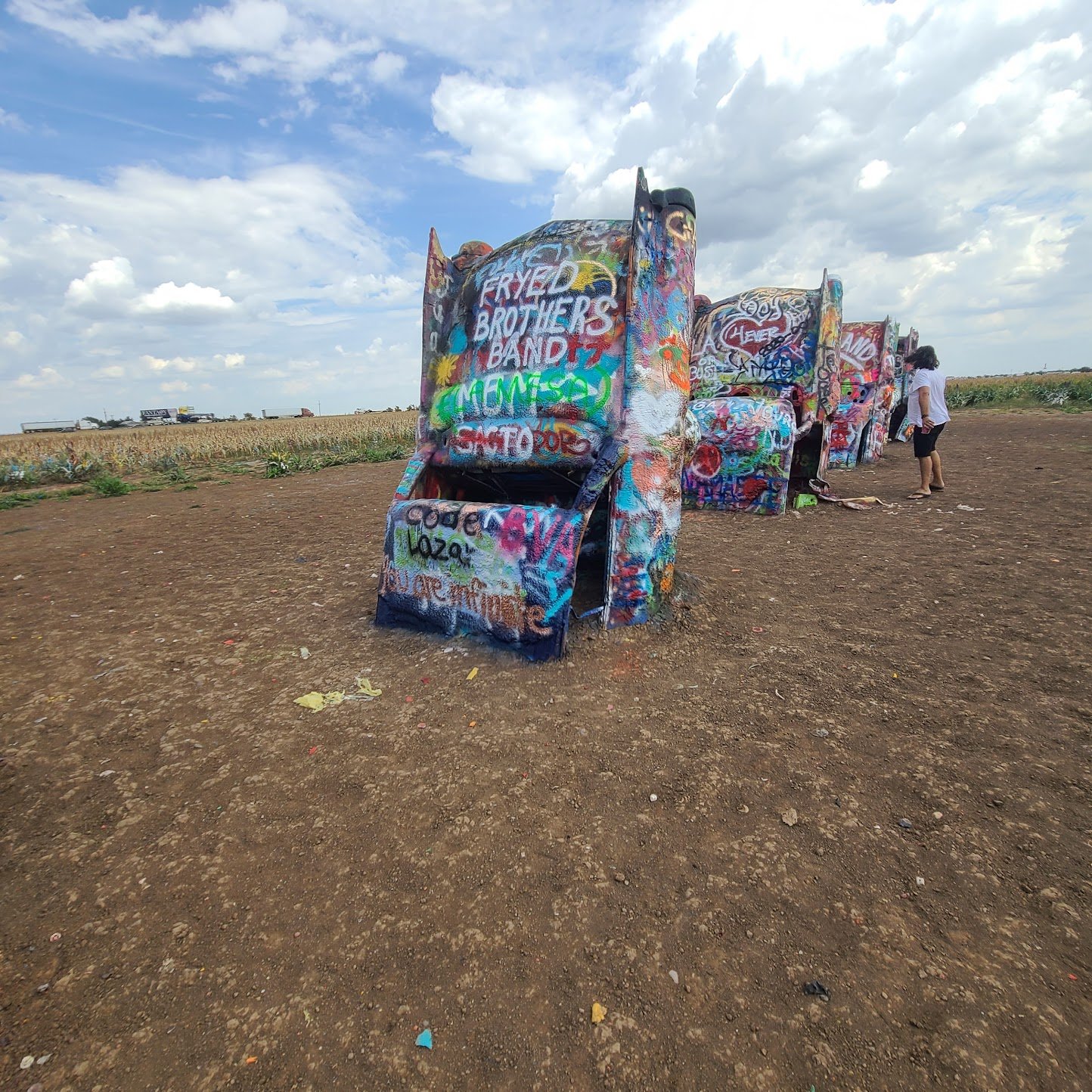 Spray painting the cars at Cadillac Ranch on Route 66 in Amarillo Texas — bring your own cans it's the whole point