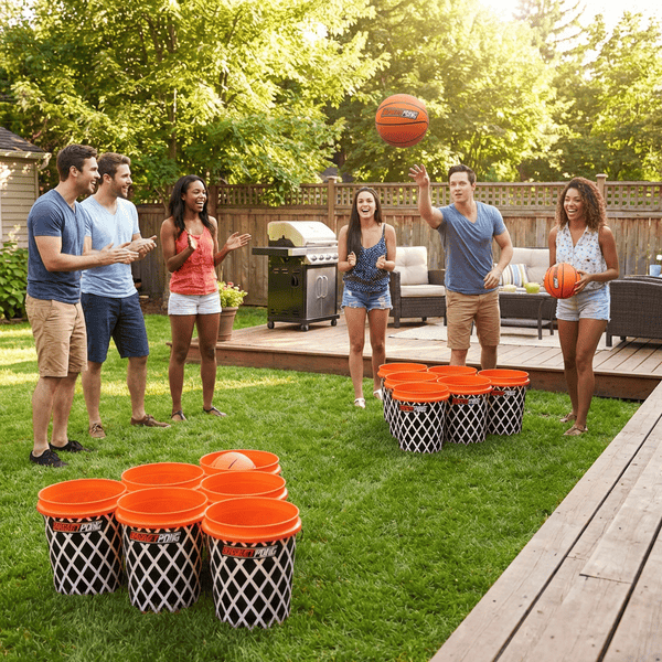Giant yard pong game being played on the beach with oversized buckets and basketballs