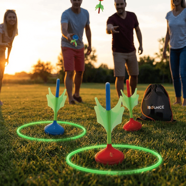 Modern safe lawn darts game with colorful weighted darts and glow in the dark target rings on a backyard lawn