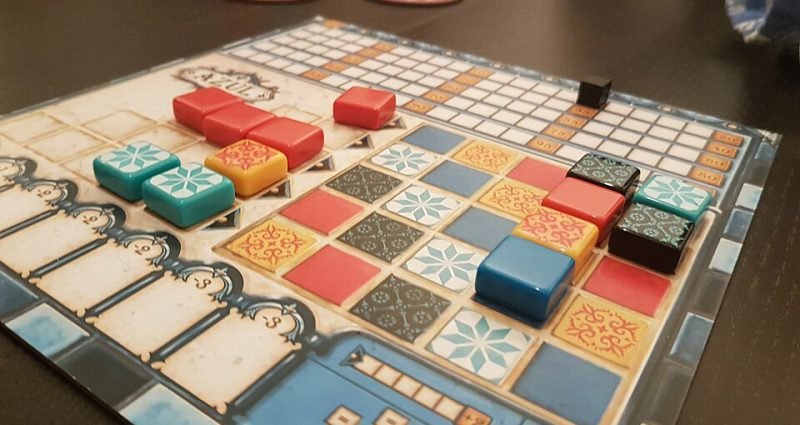 Azul tiles neatly placed on a player board